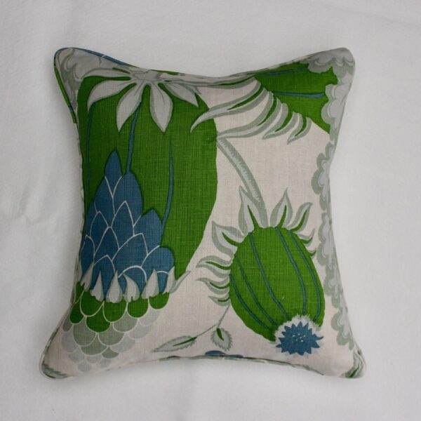 A Christopher Farr - Carnival Green pillow with a floral pattern.