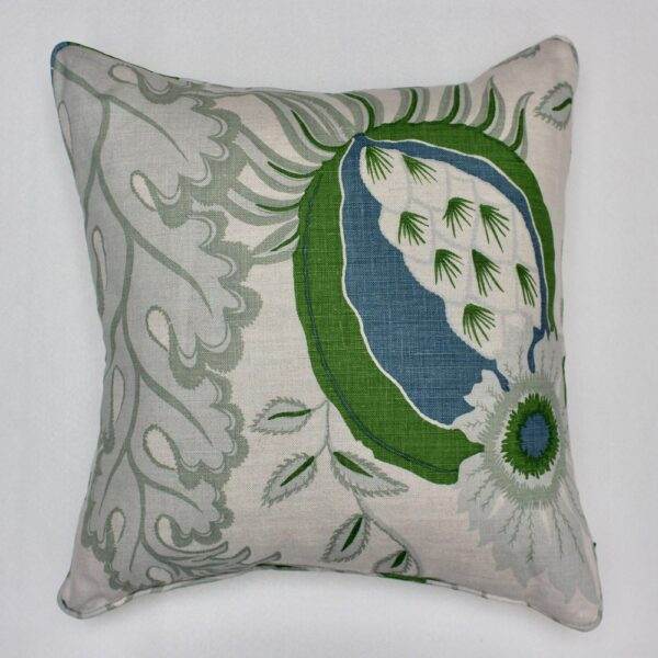 A Christopher Farr - Carnival Green pillow with a floral design.