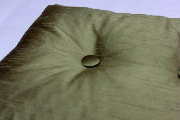 A James Hare Faux Silk - Olive Green, Buttoned pillow.