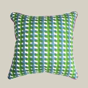 A Christopher Farr - Cremaillere Green cushion with a checkered pattern.
