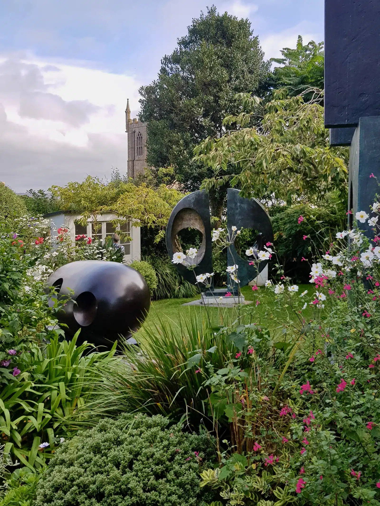 A garden with a large sculpture in the middle of it.