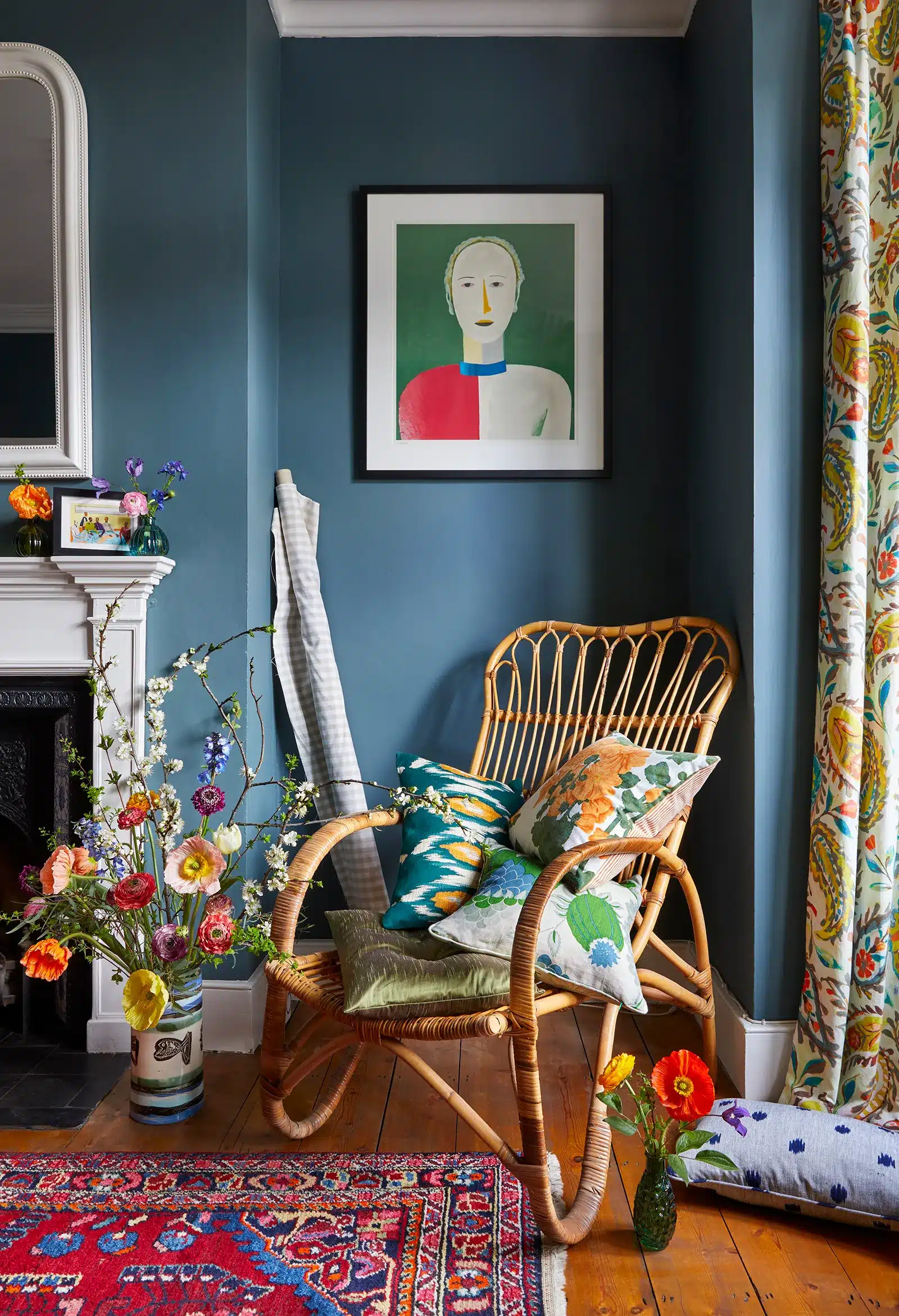 A living room with *blue walls* and a *wicker chair*.