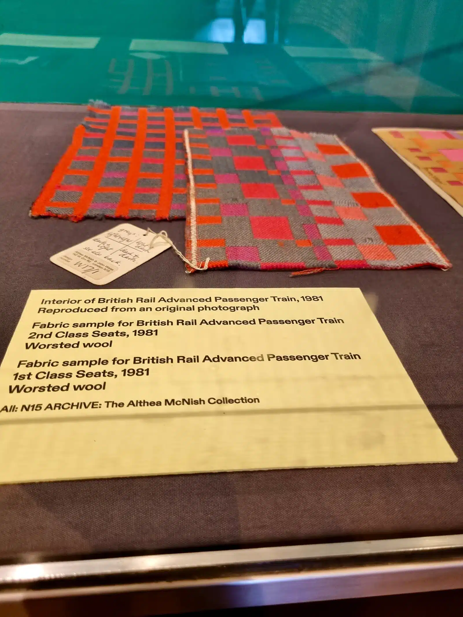 A display of a collection of textiles in a glass case.