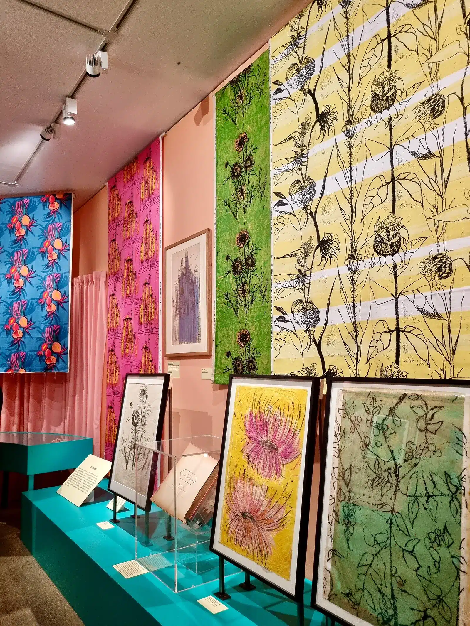 A display of colorful prints on display in a museum.