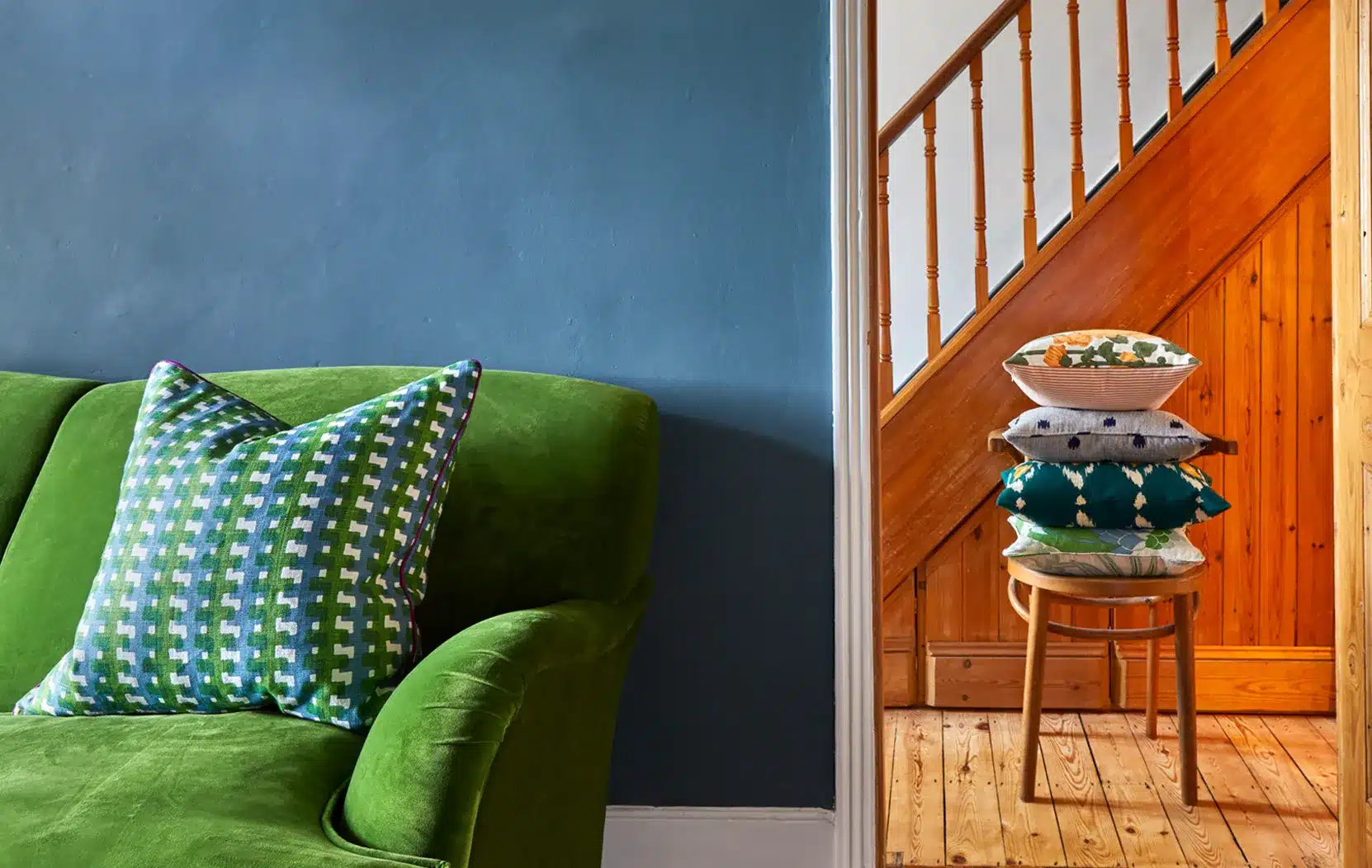 A living room with a green sofa and made to measure curtains.